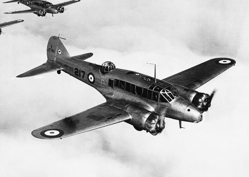 An Avro Anson Mk I of No. 217 Squadron banking in flight in 1937, with two more Ansons in formation above.