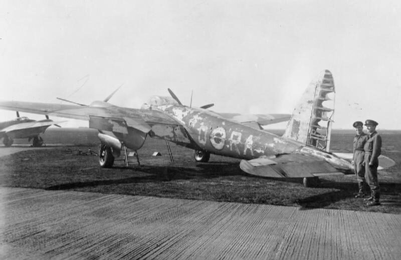 Mosquito NF Mk II DZ757 of No. 410 Squadron RCAF at Coleby Grange, its paintwork scorched after destroying a Dornier Do 217 on the night of 27 September 1943, with its crew, Flight Lieutenant M A Cybulski and Flying Officer H H Ladbrook, standing by the tail.