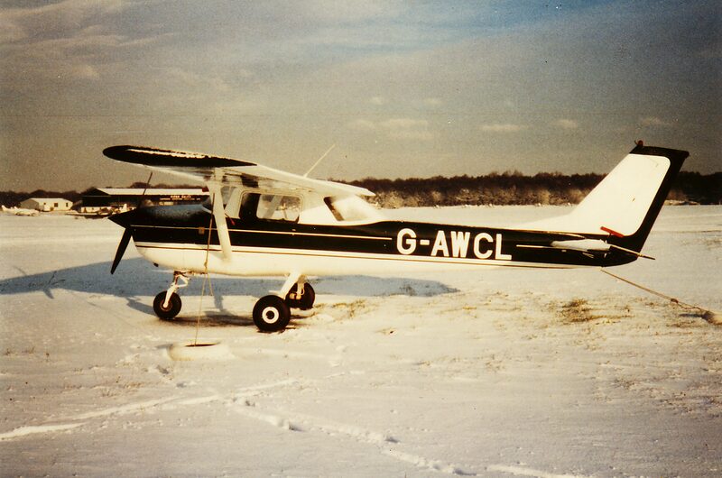 Cessna 150 G-AWCL parked on a snow-covered airfield at Biggin Hill under a winter sky.